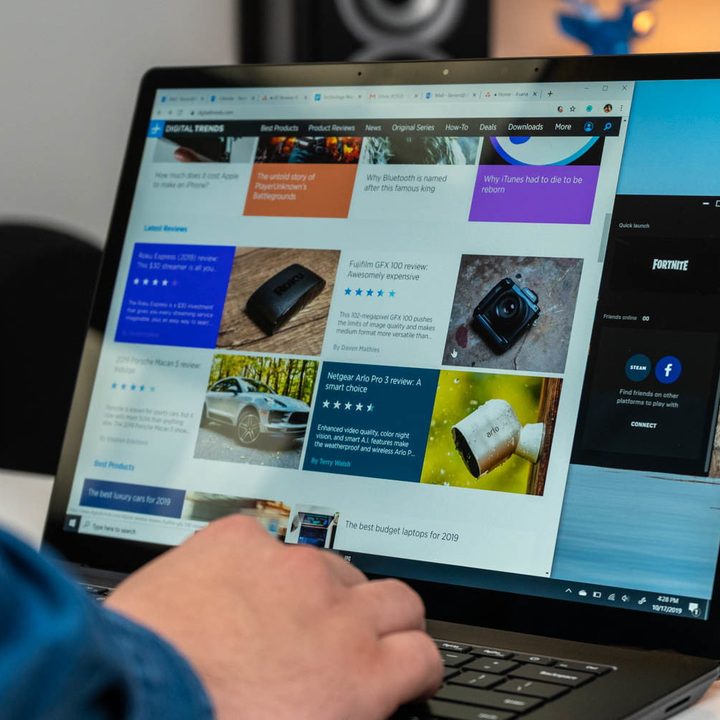A person in front of a Windows 10 laptop.