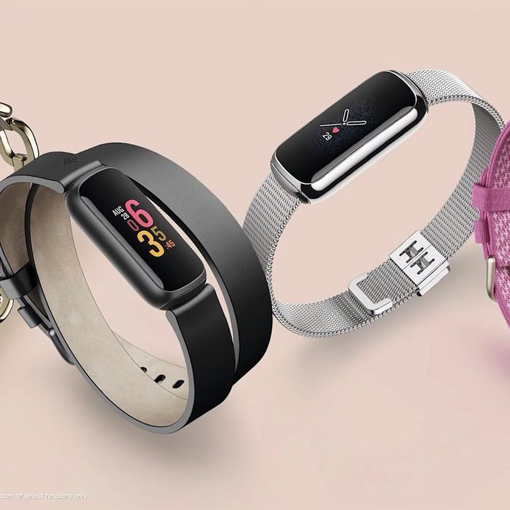 Four Fitbit Luxe trackers with various styles of bands in metalic, pink, and sillicone.