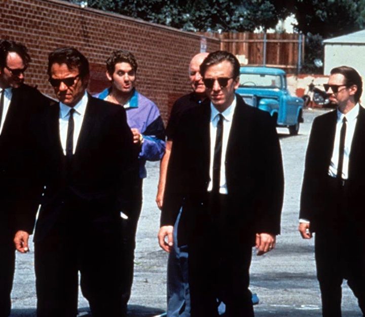 Men in suits walk down the road in Reservoir Dogs.