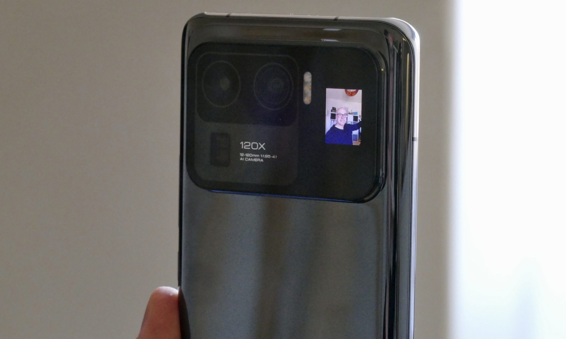 Xiaomi Mi 11 Ultra with black ceramic back and secondary display alongside the camera bump.