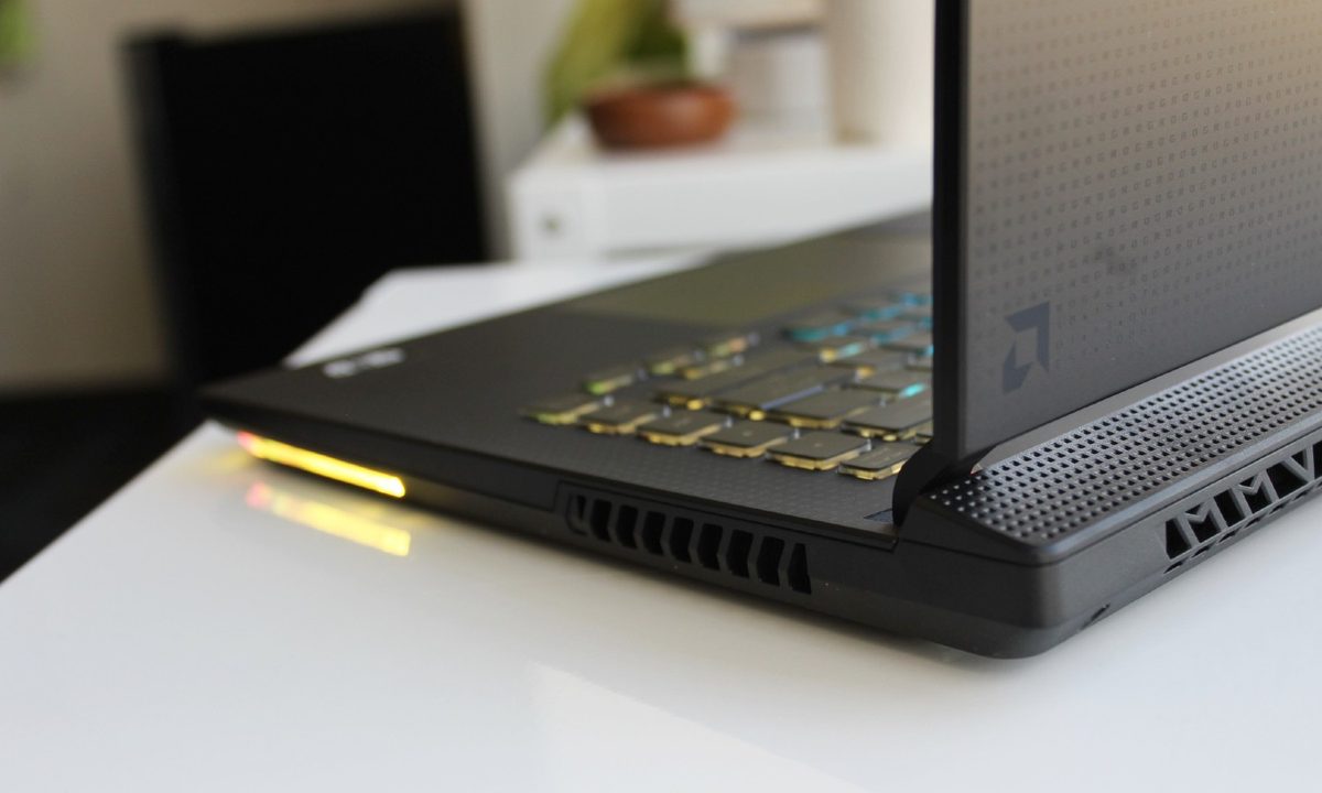 The ROG Strix G15 Advantage on a table, showing the AMD logo.