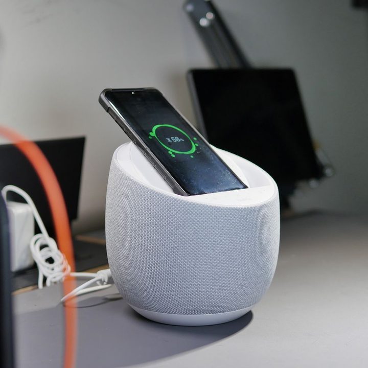 Belkin SoundForm Elite Hi-Fi wirelessly charging smartphone.