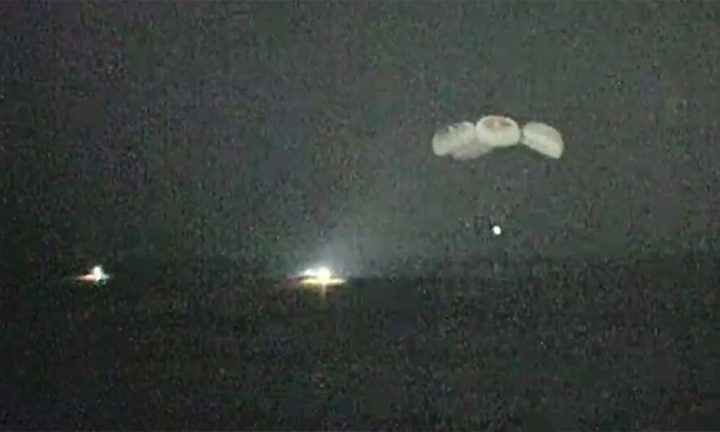 A night-vision camera captures the SpaceX Crew Dragon parachuting to splashdown in the Gulf of Mexico as fast boats arrive to retrieve the crew.