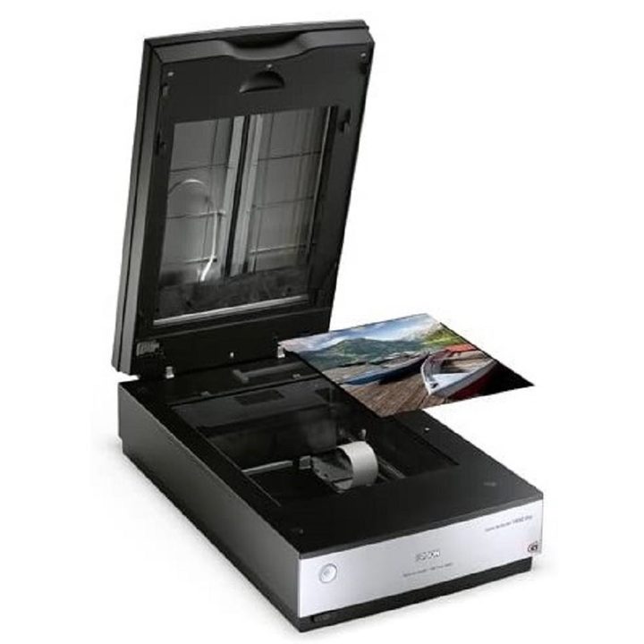 A photo of the Epson Perfection V850 Pro Scanner opened as a photo is being placed in it.