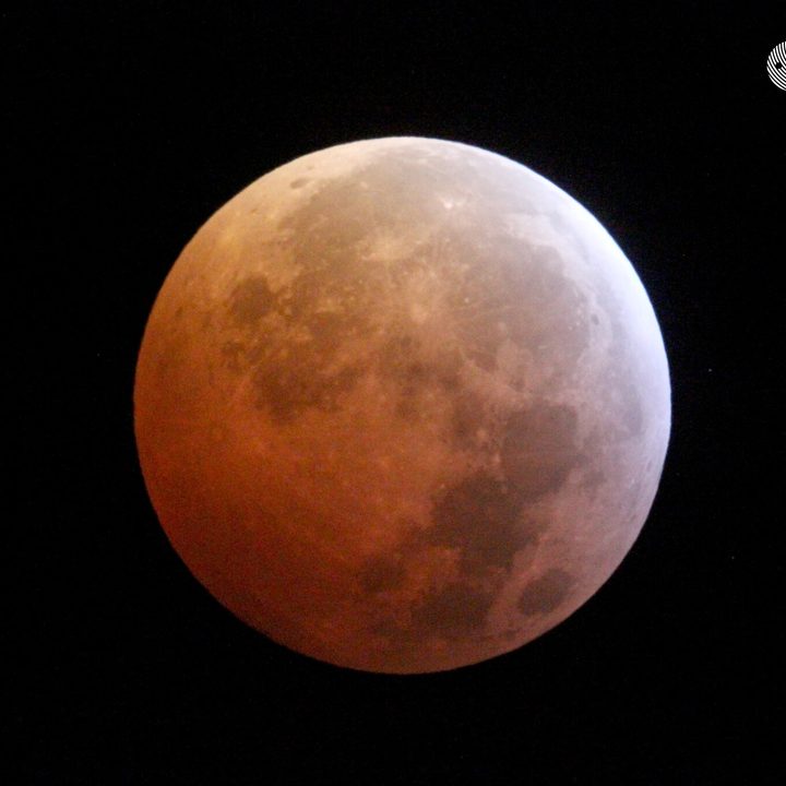 Image of the moon cast in a red-orange tint during a previous lunar eclipse in 2019.