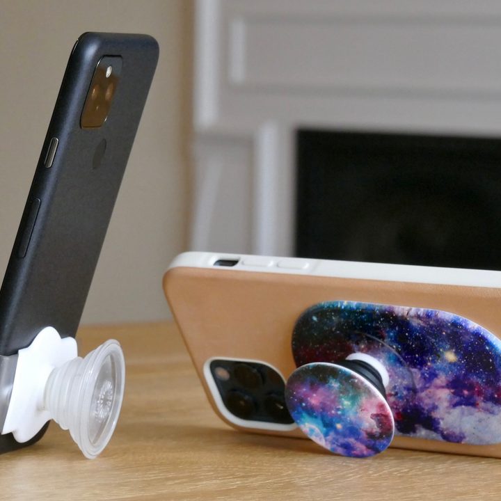PopGrips attached to two iPhones.