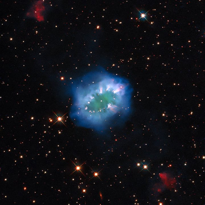 The interaction of two doomed stars has created this spectacular ring adorned with bright clumps of gas – a diamond necklace of cosmic proportions. Fittingly known as the “Necklace Nebula,” this planetary nebula is located 15,000 light-years away from Earth in the small, dim constellation of Sagitta (the Arrow).