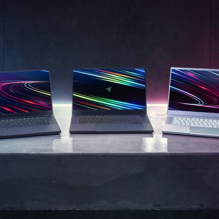 Three Razer Blade laptops sit on a desk.