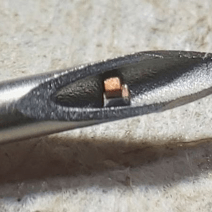 small health tracking chip shown inside the tip of a hypodermic needle