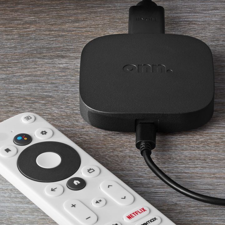 Android TV streaming device and controller on table.