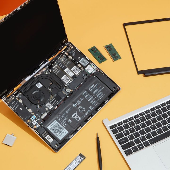 The Framework Laptop with replaceable parts on an orange background.