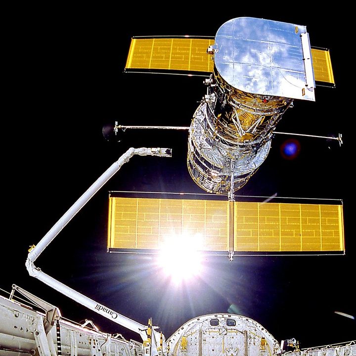 The Hubble Space Telescope is deployed on April 25, 1990 from the space shuttle Discovery. Avoiding distortions of the atmosphere, Hubble has an unobstructed view peering to planets, stars and galaxies, some more than 13.4 billion light years away.