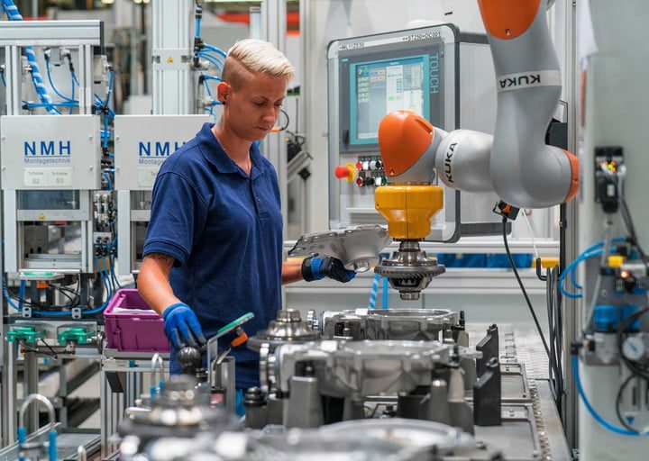 BMW factory worker using robotic arm