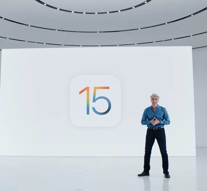 Apple's Craig Federighi makes a presntation in front of the iOS 15 logo.