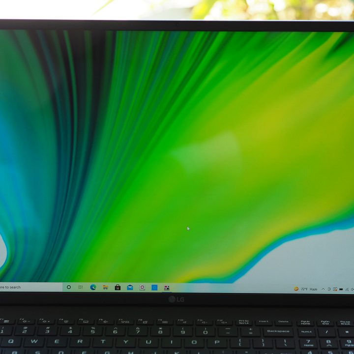 A close up shot of LG Gram 17 2021 laptop open, placed on a brick walkway.