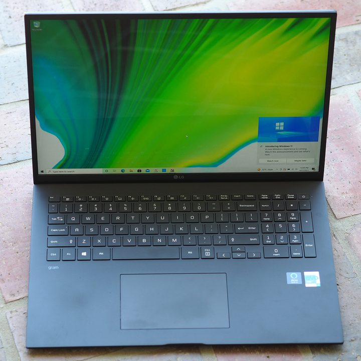 An LG Gram 17 2021 open, placed on a brick walkway.