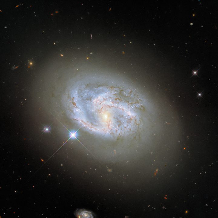 This image, taken with Hubble&rsquo;s Wide Field Camera 3, features the spiral galaxy NGC 4680. Two other galaxies, at the far right and bottom center of the image, flank NGC 4680. NGC 4680 enjoyed a wave of attention in 1997, as it played host to a supernova explosion known as SN 1997bp. Australian amateur astronomer Robert Evans identified the supernova and has identified an extraordinary 42 supernova explosions. 