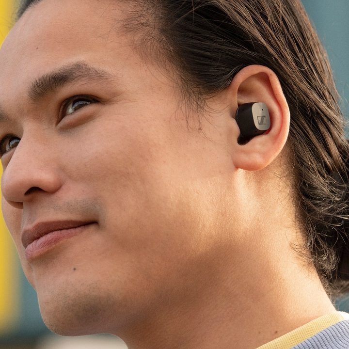 Sennheiser CX True Wireless earbuds worn by a male model.