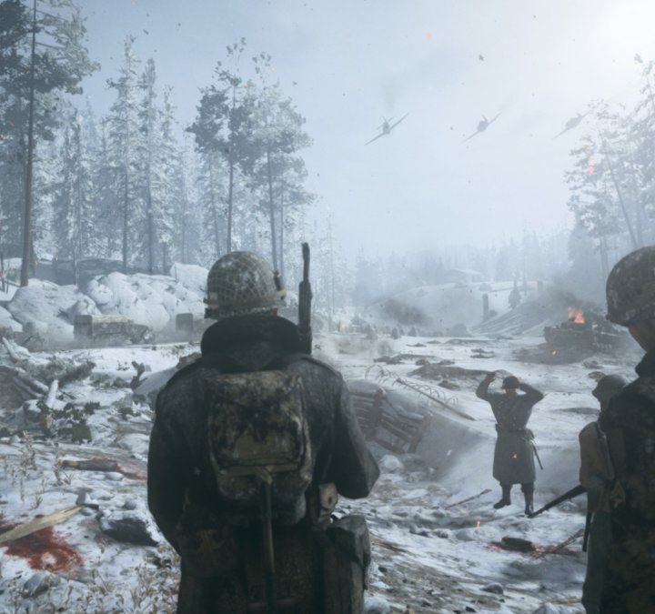 Soldiers walking through a snowy battlefield.