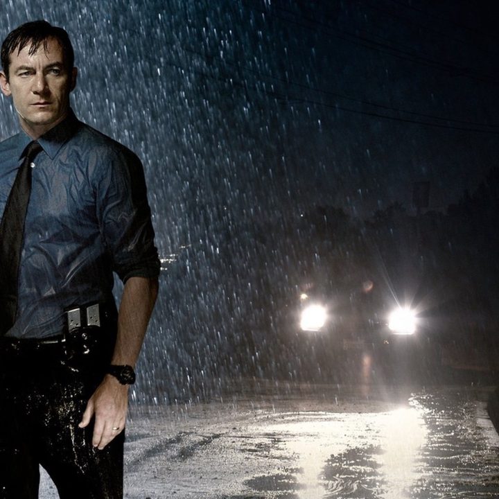LAPD detective Michael Britten stands in the rain.