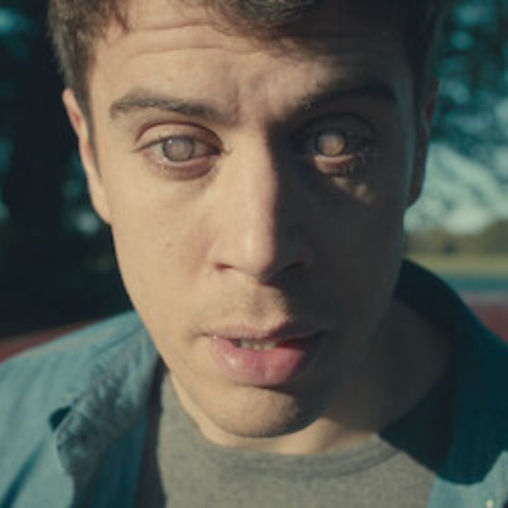 A character with strange eyes stares in Black Mirror.