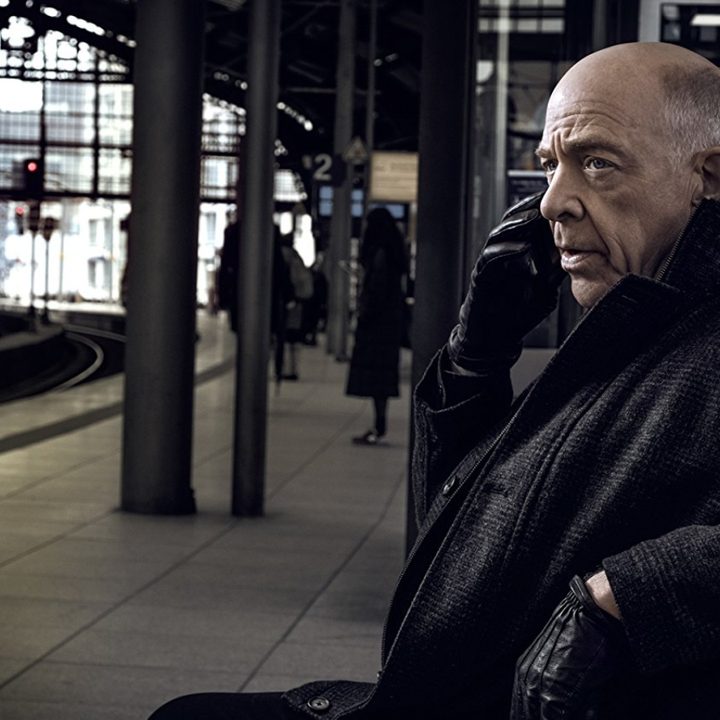J.K. Simmons sits in a train station in the series Counterpart.