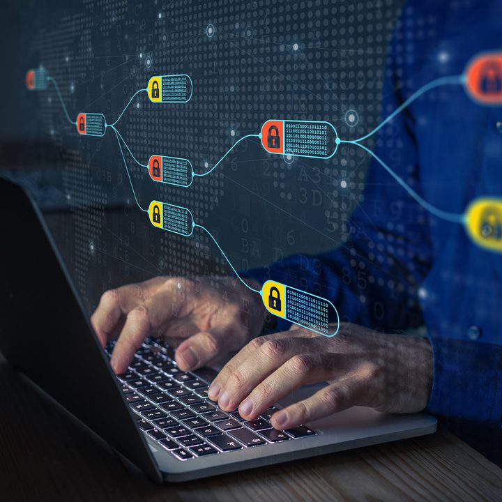 Blockchain graphic with person working on computer