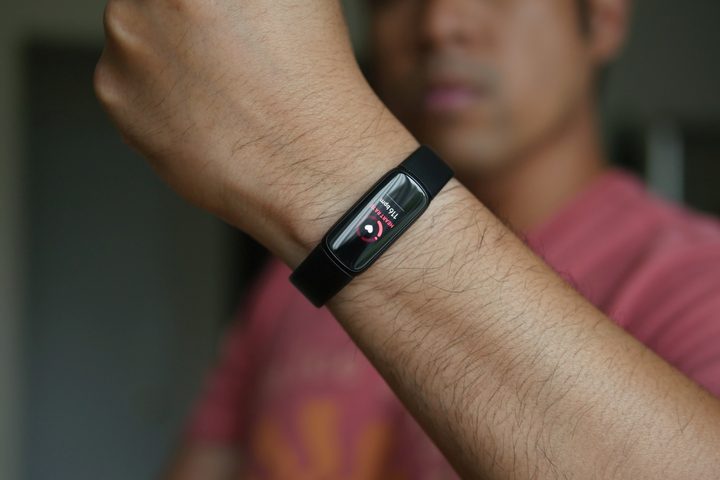 The Fitbit Luxe fitness tracker on a person's wrist.