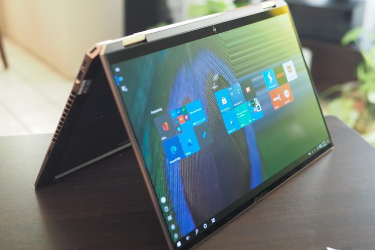 HP Spectre x360 15 tent view showing display, ports, and hinge.