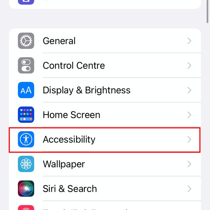 The Settings menu of iOS 15. Accessibility is highlighted in red.