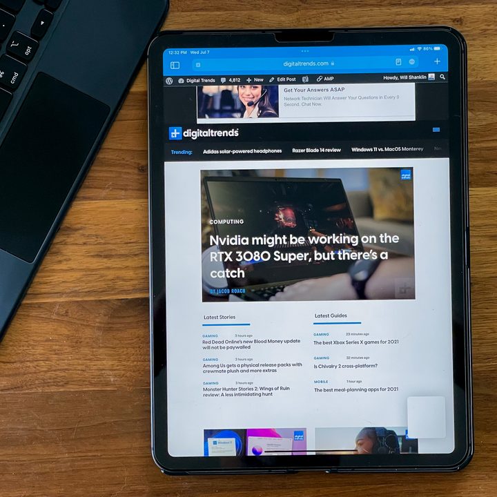 iPad Pro running iPadOS 15, with the Digital Trends homepage on the screen, Apple Pencil to the right and keyboard to the left.