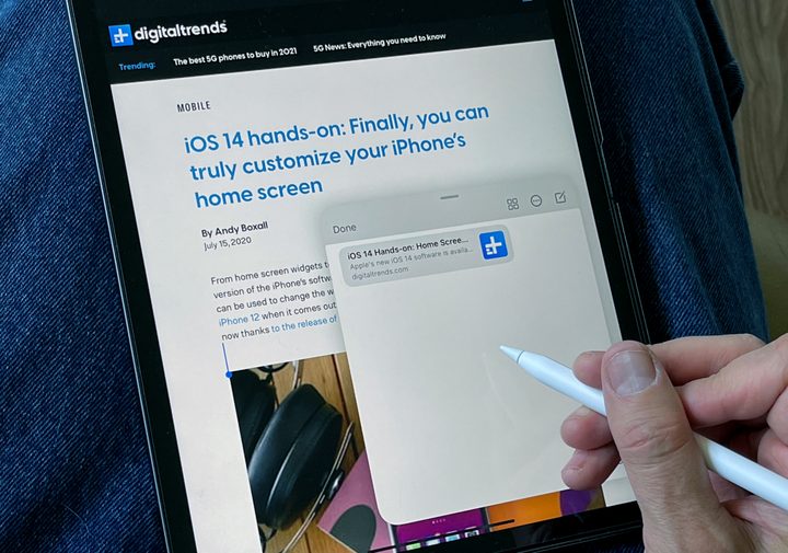 Apple Pencil pointing at the multitasking menu on an iPad screen