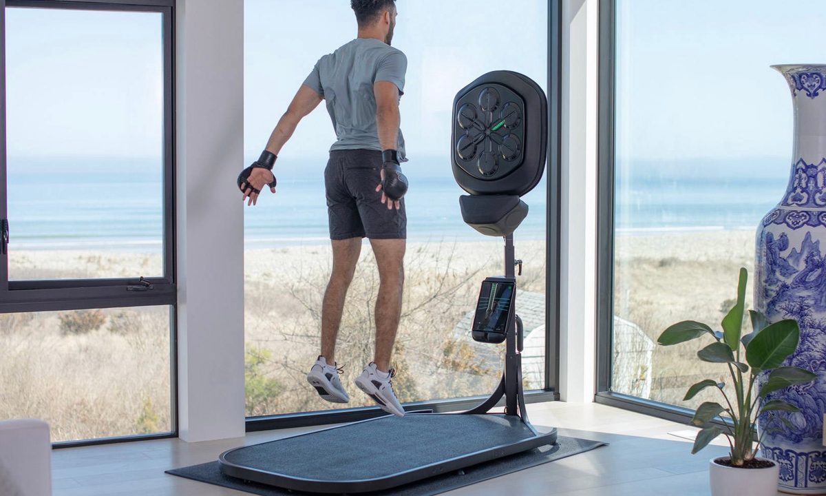 A man using a Liteboxer jumps during his workout.