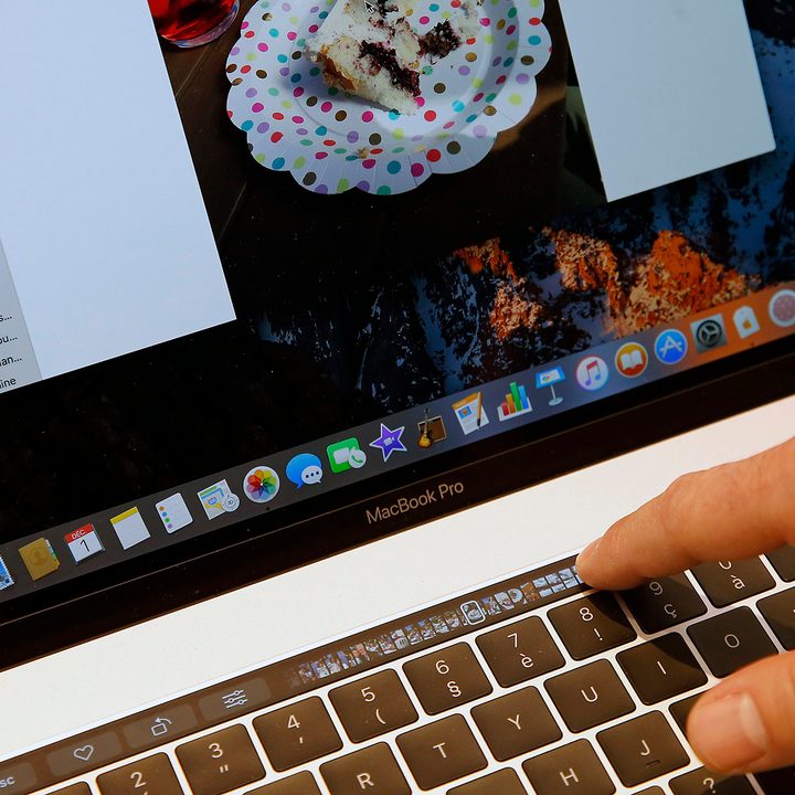 Close-up of person using a Macbook Pro Touch Bar.