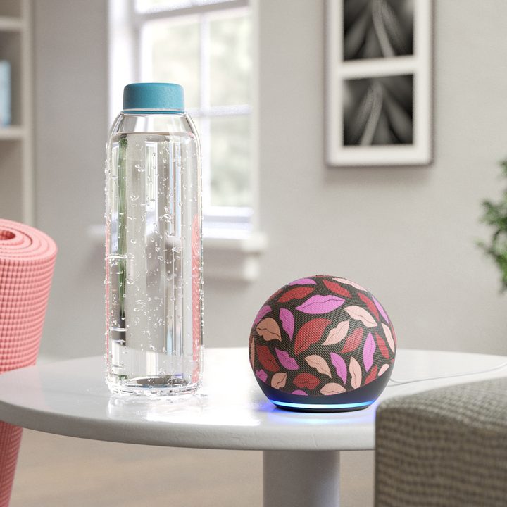 Amazon Echo Dot Diane von Furstenberg concept on a table with a water bottle nearby.