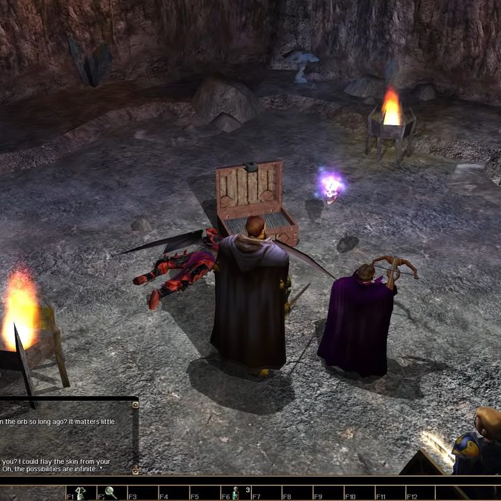 Two adventurers looting a chest in a cave.