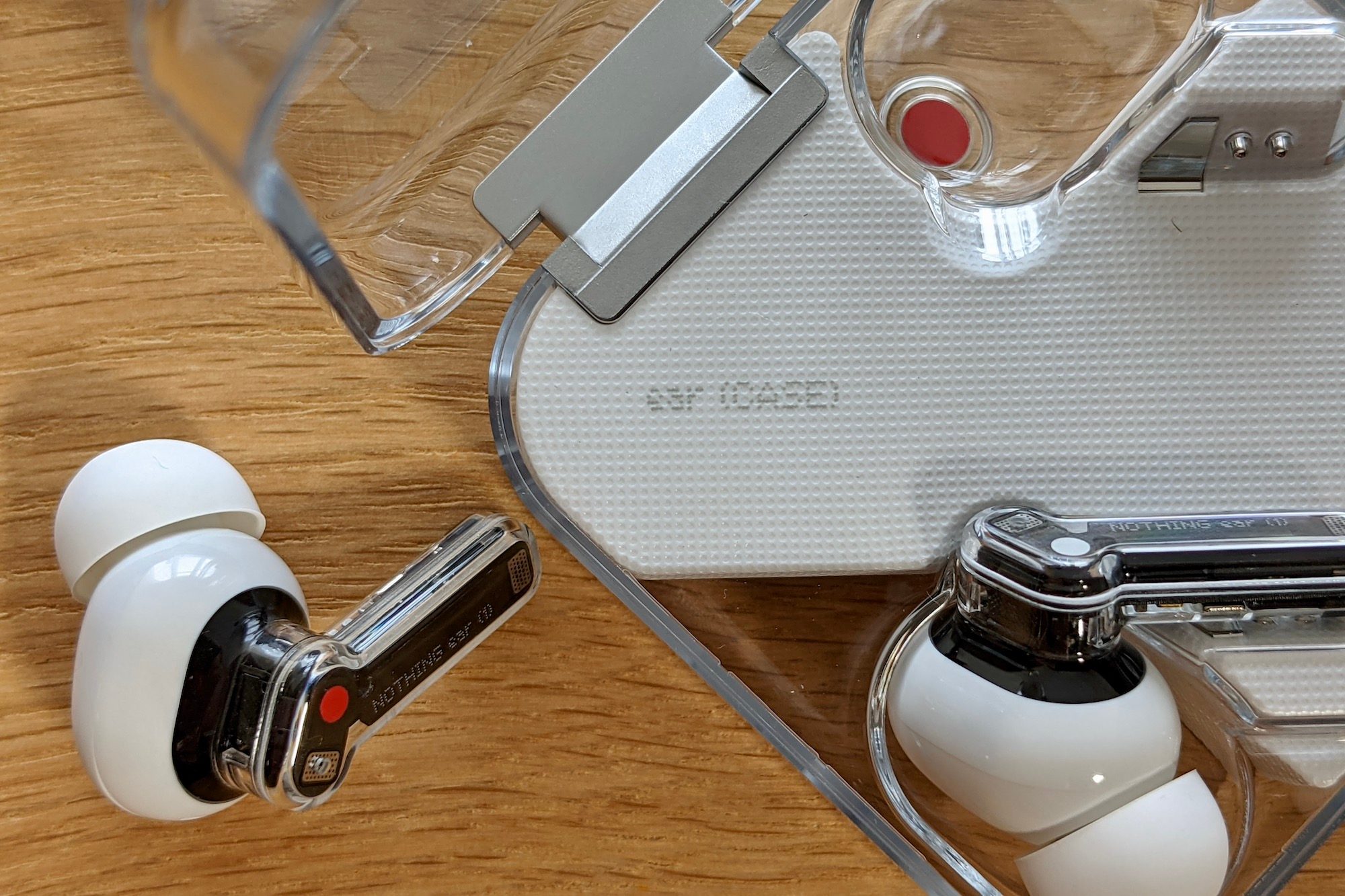 Close-up of the Nothing Ear 1 case and earbuds.