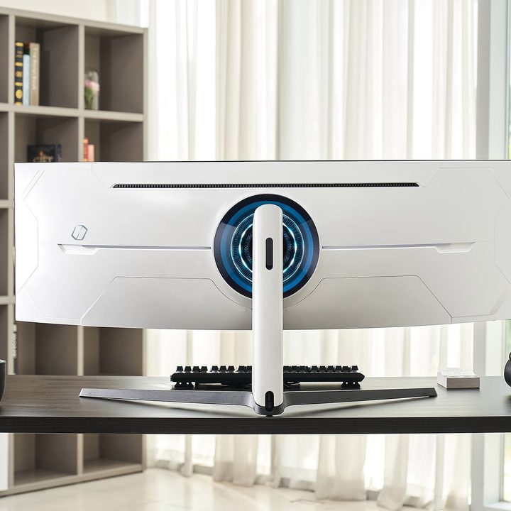 A view of the rear of the Samsung Odyssey Neo G9 gaming monitor on a desk in a home office space.