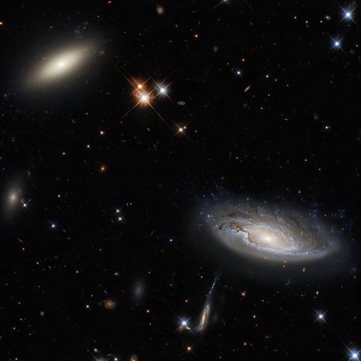 Two enormous galaxies shine. The galaxy on the left is a lenticular galaxy, named 2MASX J03193743+4137580. The side-on spiral galaxy on the right is named UGC 2665.