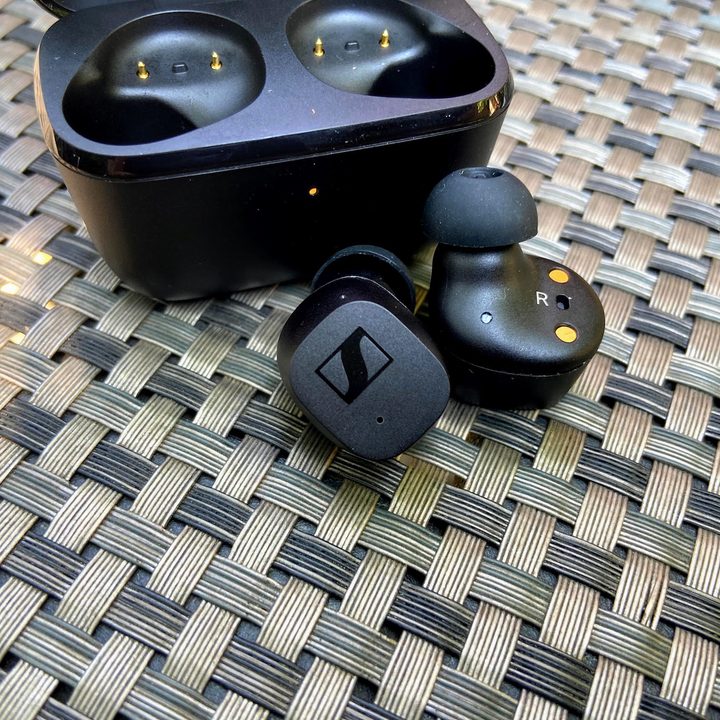 Sennheiser CX True Wireless earbuds beside charging case.
