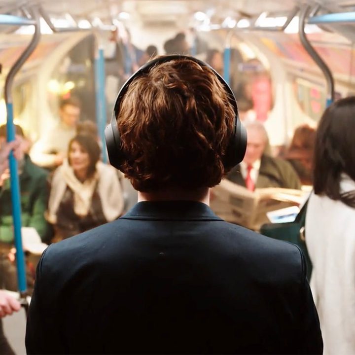 Man wearing Sony WH-1000XM4 ANC Headphones on public transportation
