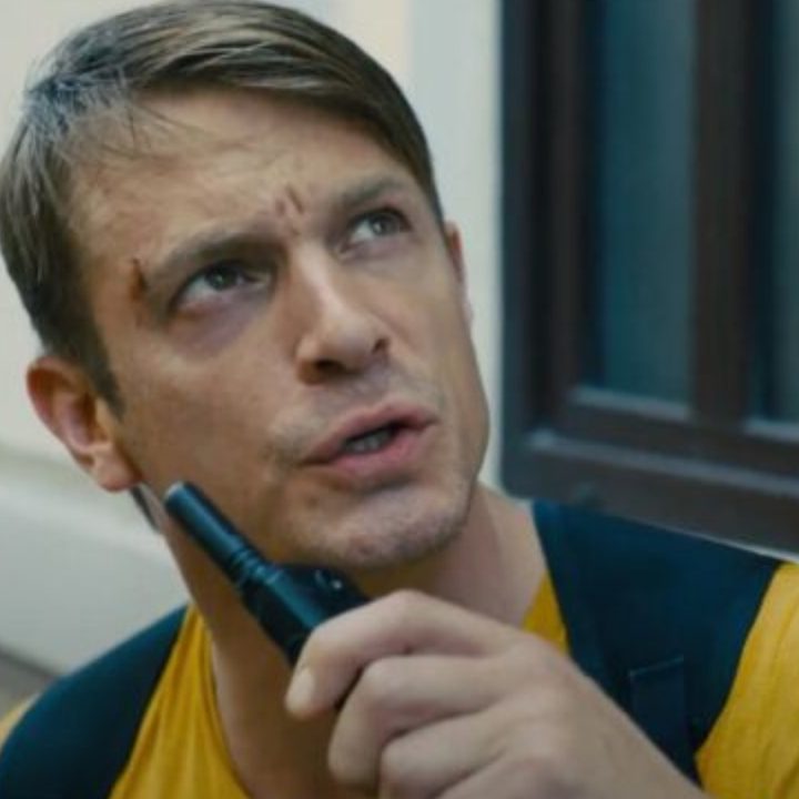 Joel Kinnaman as Rick Flag talking on a walkie talkie.