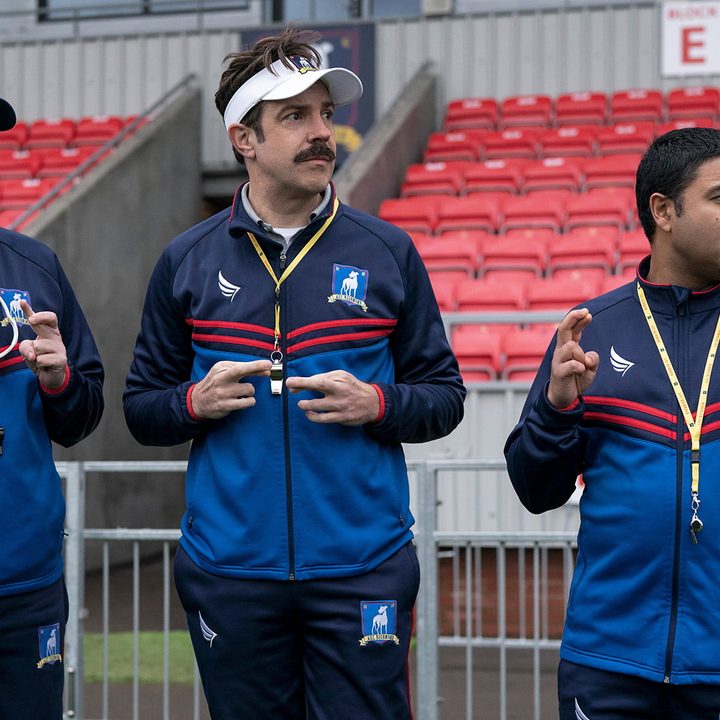 Ted Lasso and his assistant coaches on the sidelines of season 2 of the Apple TV+ original series.