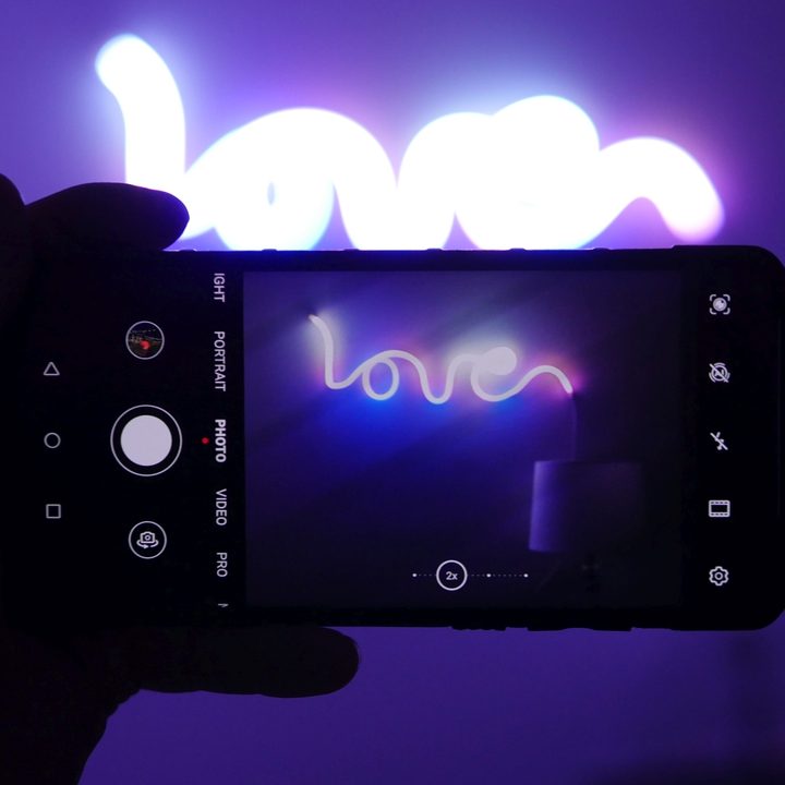 Using smartphone camera to take photo of Twinkly Flex on wall.