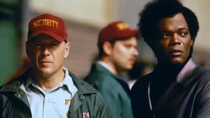 David Dunne and Mr. Glass standing side-by-side and lokking in different directions in the movie Unbreakable.
