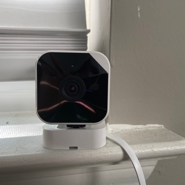 Abode Cam 2 sitting on window sill.