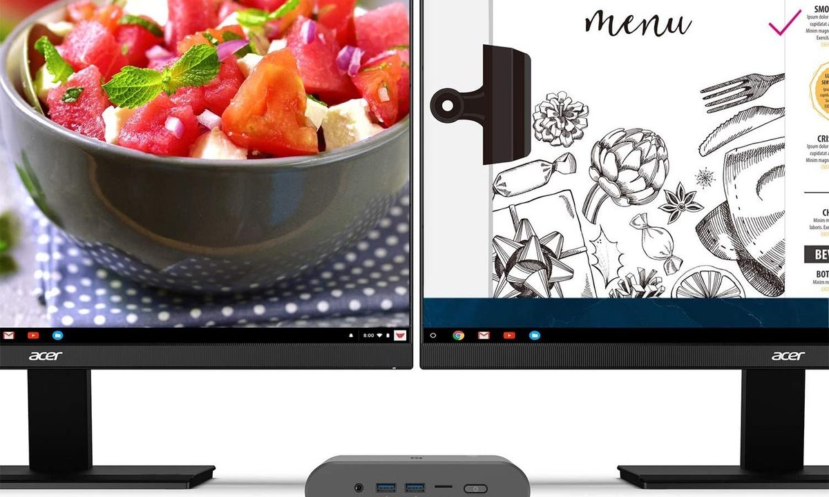 An Acer Chromebox sitting between two monitors.