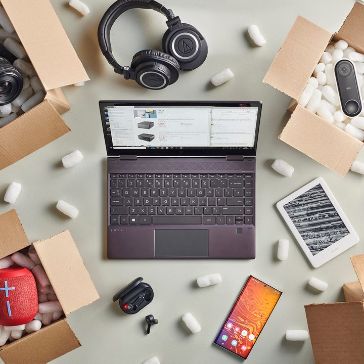 Laptop on Amazon surrounded by boxes of tech gear.