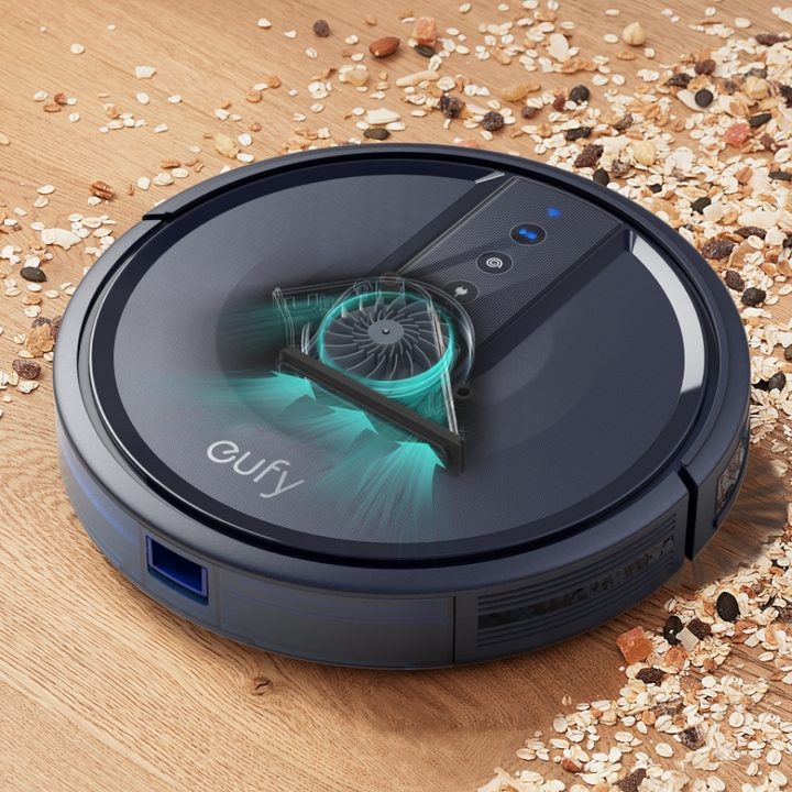 Anker Eufy Robovac vacuuming oats, dried fruit, and nuts from a hardwood floor.