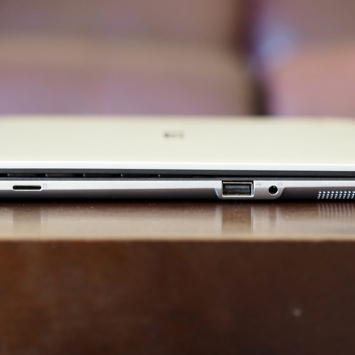 Left side view of the Asus Chromebook Flip CM3. Featuring: Micro USB port, micro SD slot, USB port, and headphone jack.